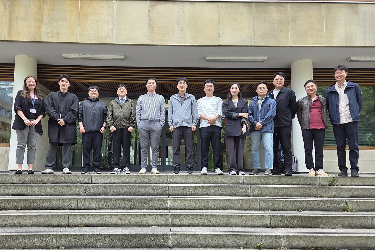 Delegates from the Korea Hydro & Nuclear Power company standing on the steps outside the Business School