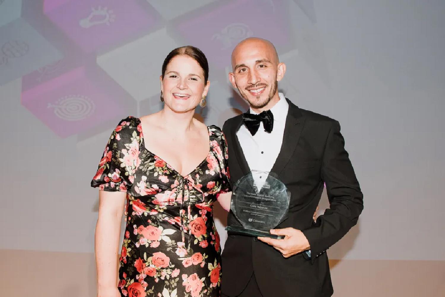 Two representatives collecting Gold Award at the Learning Technologies Awards