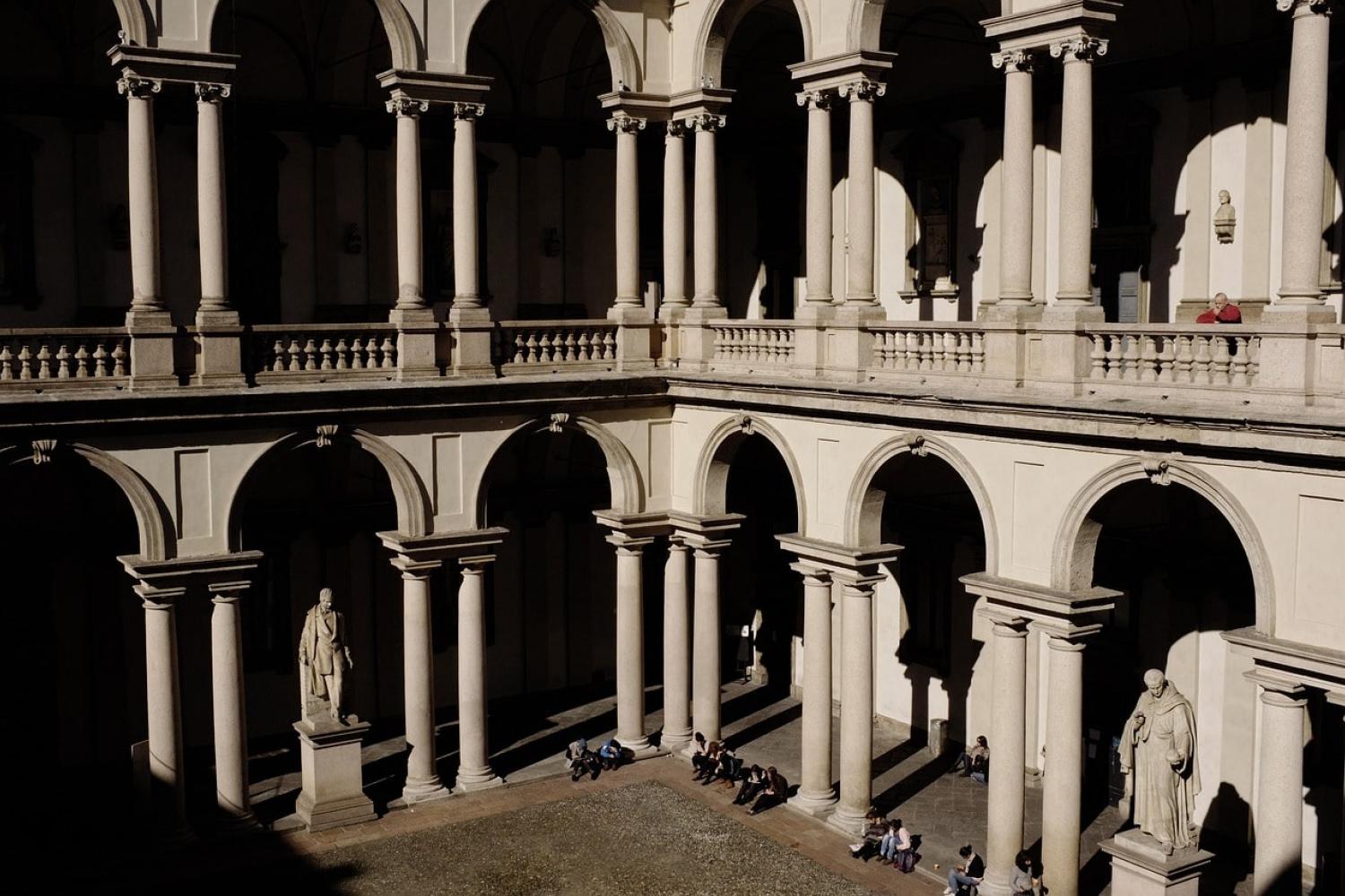 Students sitting on steps in Milan