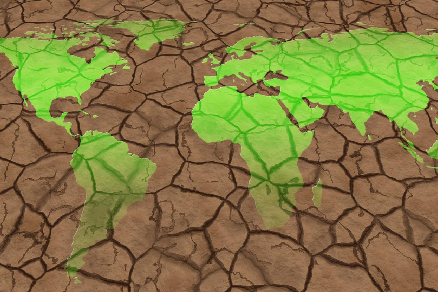 Map of world on background of dried out earth 