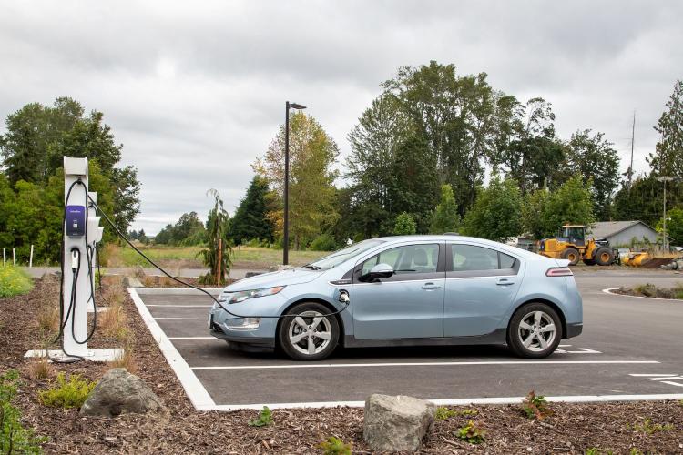 Electric car charging at an electric vehicle charging point