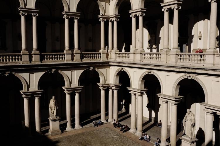 Students sitting on steps in Milan