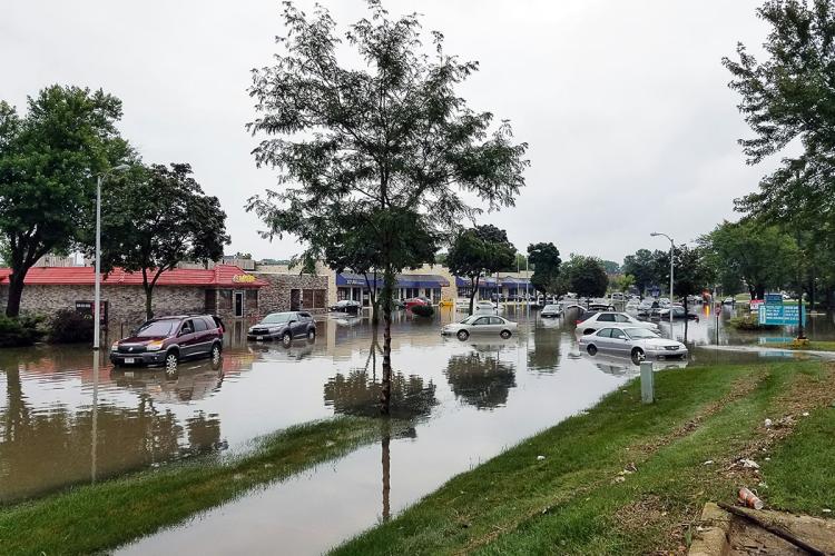 Flooded street and cars in the water in an urban north American streetscape
