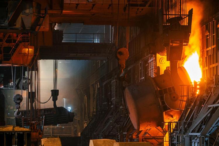 Inside of a steel plant with furnace and fire